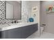 Modern powder room featuring geometric tiling, floating vanity and designer fixtures at 650 Scenic Cliff Dr, Henderson, NV 89012