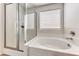 Bright bathroom featuring a soaking tub and glass shower at 7012 Mercurio Ave, Las Vegas, NV 89131