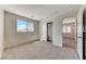 Bright bedroom with neutral carpet, light walls, and closet with sliding doors; a window provides natural light at 7012 Mercurio Ave, Las Vegas, NV 89131