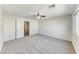 Spacious bedroom with neutral carpet, ceiling fan and natural light at 7012 Mercurio Ave, Las Vegas, NV 89131