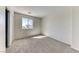 Cozy bedroom featuring neutral carpet, light walls, a closet with sliding doors, and a bright window at 7012 Mercurio Ave, Las Vegas, NV 89131