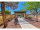 Charming community gazebo with stone pillars, a picnic table, and a walkway, surrounded by landscaping at 7012 Mercurio Ave, Las Vegas, NV 89131