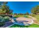 Beautiful community park with lush green space, seating areas, and walking paths under a bright blue sky at 7012 Mercurio Ave, Las Vegas, NV 89131