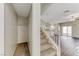 View of home entry with carpeted staircase leading to a living area with a sliding door and hardwood flooring at 7012 Mercurio Ave, Las Vegas, NV 89131