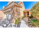 Close-up showcasing the home's entrance, highlighting the manicured landscaping and covered walkway, inviting appeal at 7012 Mercurio Ave, Las Vegas, NV 89131
