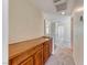 Upstairs hallway featuring built-in wooden storage cabinet at 7012 Mercurio Ave, Las Vegas, NV 89131