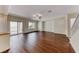 Spacious living room with rich wood flooring, neutral walls, and sliding glass doors to a patio, bright space at 7012 Mercurio Ave, Las Vegas, NV 89131