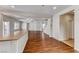 Bright open-concept living area with hardwood floors, leading to a staircase and outdoor patio at 7012 Mercurio Ave, Las Vegas, NV 89131