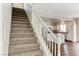 Carpeted staircase with white railing leads to the upper level and kitchen area at 7012 Mercurio Ave, Las Vegas, NV 89131