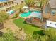 Aerial view of a backyard featuring a pool, putting green and an outdoor kitchen at 7354 Strutting Silver Ct, Las Vegas, NV 89131