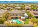 Aerial view of backyard with pool, putting green, and covered patio at 7354 Strutting Silver Ct, Las Vegas, NV 89131