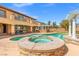 Luxurious backyard with a pool, spa, covered patio, and a lush landscaped yard at 7354 Strutting Silver Ct, Las Vegas, NV 89131
