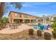 Spacious backyard with pool, spa, patio, pergola, outdoor seating, and lush landscaping at 7354 Strutting Silver Ct, Las Vegas, NV 89131