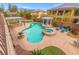 Aerial view of a backyard oasis with a pool, spa, covered seating areas, and lush landscaping at 7354 Strutting Silver Ct, Las Vegas, NV 89131