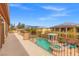 Balcony view featuring an outdoor pool, pergola, and landscaping with neighborhood views at 7354 Strutting Silver Ct, Las Vegas, NV 89131