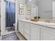 Bathroom featuring double sinks, neutral paint, and framed artwork at 7354 Strutting Silver Ct, Las Vegas, NV 89131