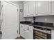 Butler pantry with granite counters, wine fridge, and white cabinets at 7354 Strutting Silver Ct, Las Vegas, NV 89131