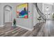 Light and bright foyer with beautiful art and modern staircase at 7354 Strutting Silver Ct, Las Vegas, NV 89131