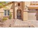 Charming two-story home featuring a large, welcoming front entrance and manicured landscaping at 7354 Strutting Silver Ct, Las Vegas, NV 89131