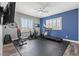Home gym with treadmill, bike, weights, and mounted television at 7354 Strutting Silver Ct, Las Vegas, NV 89131
