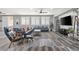 Open-concept living room with natural light, modern furniture, and ceiling fans at 7354 Strutting Silver Ct, Las Vegas, NV 89131