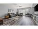 Spacious living room with hardwood floors, ceiling fan, comfortable seating, and plantation shutters at 7354 Strutting Silver Ct, Las Vegas, NV 89131