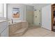 Updated main bathroom featuring a glass shower and separate soaking tub at 7354 Strutting Silver Ct, Las Vegas, NV 89131