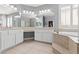 Elegant main bathroom with double vanity, soaking tub, and modern fixtures at 7354 Strutting Silver Ct, Las Vegas, NV 89131
