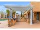 Outdoor kitchen with a built-in grill and bar, next to the pool at 7354 Strutting Silver Ct, Las Vegas, NV 89131