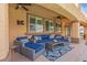 Inviting covered patio with comfortable seating, ceiling fans, and bright natural light from the large windows at 7354 Strutting Silver Ct, Las Vegas, NV 89131