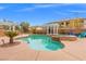 Backyard pool features a spa, two pergolas, an outdoor seating area, and mature landscaping at 7354 Strutting Silver Ct, Las Vegas, NV 89131