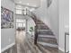 Staircase featuring a decorative handrail, neutral tones, and wood-look flooring at 7354 Strutting Silver Ct, Las Vegas, NV 89131