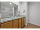 Stylish bathroom featuring a modern double sink vanity, granite countertops, and a glass-enclosed shower at 7849 Lily Trotter St, North Las Vegas, NV 89084