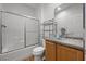 Bathroom featuring a tub, granite vanity top with vessel sink, and a large mirror at 7849 Lily Trotter St, North Las Vegas, NV 89084