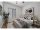 Comfortable bedroom with a ceiling fan, stylish decor, and natural light at 7849 Lily Trotter St, North Las Vegas, NV 89084