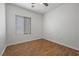 Bedroom with wood-look tile flooring, a ceiling fan, and natural light from the window at 7849 Lily Trotter St, North Las Vegas, NV 89084