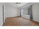 Bright bedroom with neutral walls, wood-look flooring, ceiling fan, and a large window for natural light at 7849 Lily Trotter St, North Las Vegas, NV 89084