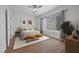 Serene bedroom with wood-look tile flooring, neutral walls, ample natural light, and ceiling fan at 7849 Lily Trotter St, North Las Vegas, NV 89084