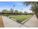 Outdoor bocce ball court with landscaping and lighting at 7849 Lily Trotter St, North Las Vegas, NV 89084