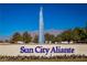 Sun City Aliante community sign with a beautiful fountain, flowers, trees, and mountain views at 7849 Lily Trotter St, North Las Vegas, NV 89084