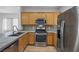Modern kitchen boasts stainless steel appliances, granite countertops, and wooden cabinets with ample storage at 7849 Lily Trotter St, North Las Vegas, NV 89084