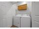 Laundry room featuring a washer, dryer, cabinets, and a tile floor at 7849 Lily Trotter St, North Las Vegas, NV 89084
