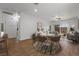 Open concept living and dining area featuring wood-look tile flooring, light neutral walls, and ample natural light at 7849 Lily Trotter St, North Las Vegas, NV 89084