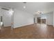 Spacious living room featuring sleek wood-look tile flooring and abundant natural light from large windows at 7849 Lily Trotter St, North Las Vegas, NV 89084