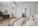 Tranquil bedroom with wood-look tile flooring, neutral walls, and ensuite bathroom access at 7849 Lily Trotter St, North Las Vegas, NV 89084