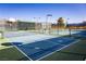 Outdoor tennis court with a basketball hoop and professional grade surfacing at 7849 Lily Trotter St, North Las Vegas, NV 89084