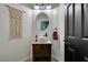 Charming powder room with decorative mirror, accent wall, and modern sink at 8073 Villa Pulido St, Las Vegas, NV 89131