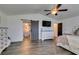 Spacious bedroom with ceiling fan, barn door entry to walk-in closet, and ensuite bathroom at 8073 Villa Pulido St, Las Vegas, NV 89131
