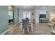 Bright dining area with elegant chandelier, wood-look flooring, and comfortable seating at 8073 Villa Pulido St, Las Vegas, NV 89131