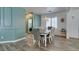 Charming dining room with elegant chandelier, wood-look floors, and laundry access at 8073 Villa Pulido St, Las Vegas, NV 89131